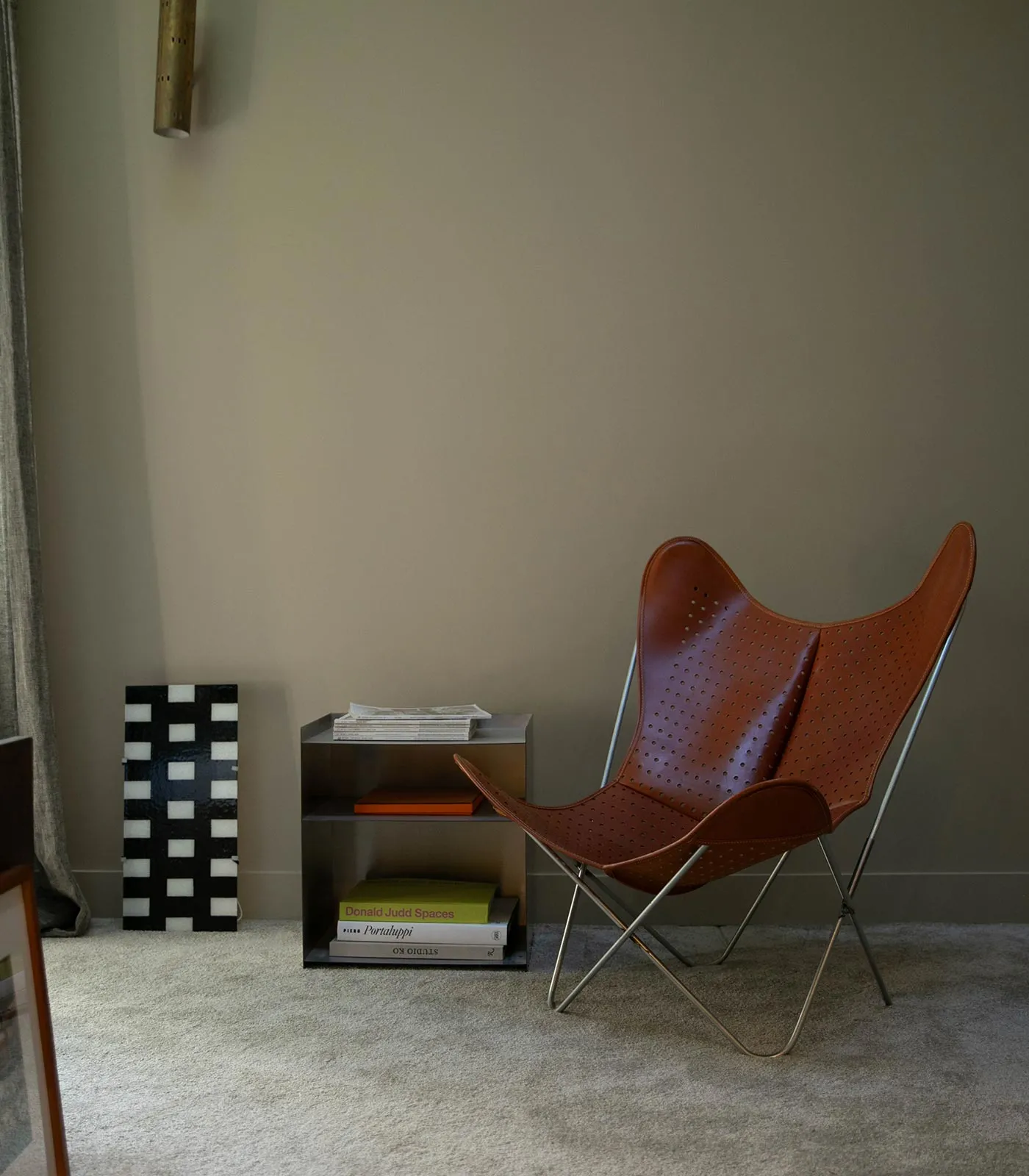 AA Butterfly© armchair in perforated cognac leather with a chrome frame